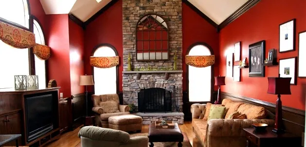 Living room with red walls and stone fireplace
