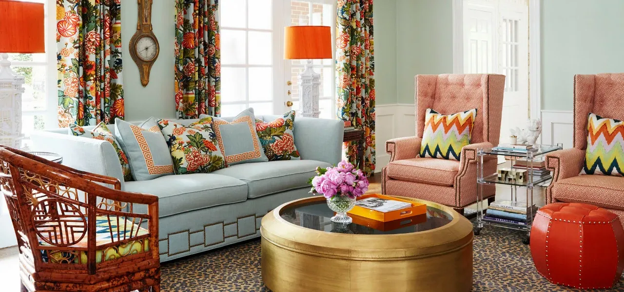 Living room with patterned curtains and orange accents